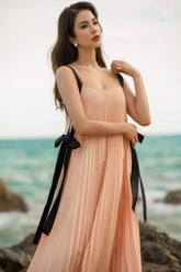 Pleated silk midi dress with ribbon tie straps and flowing A-line silhouette for elegant movement